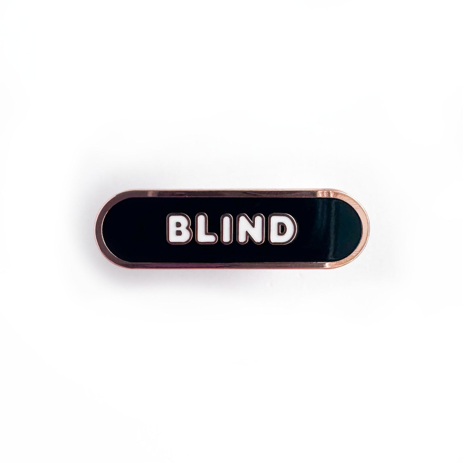 Oval shaped enamel pin with "blind" written in white text on a black background.
