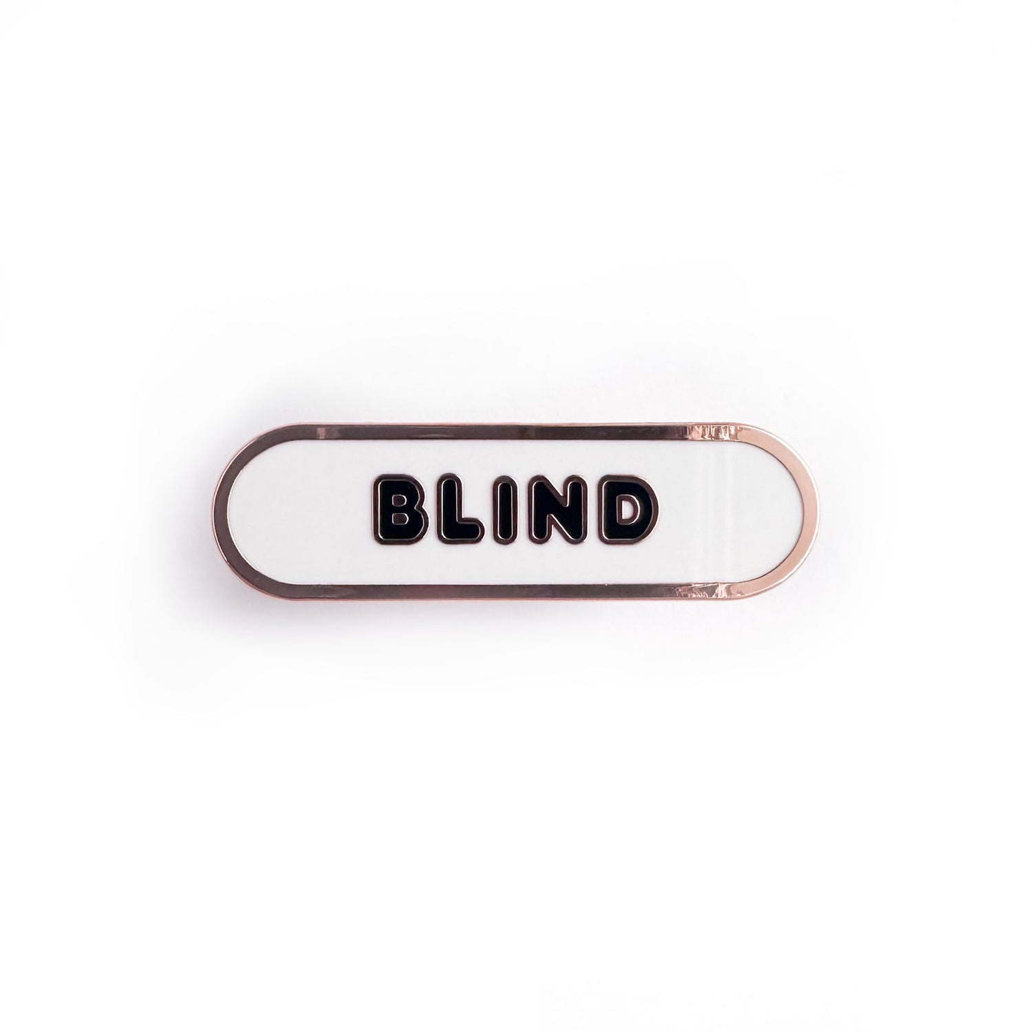Oval shaped enamel pin with "blind" written in black text on a white background.
