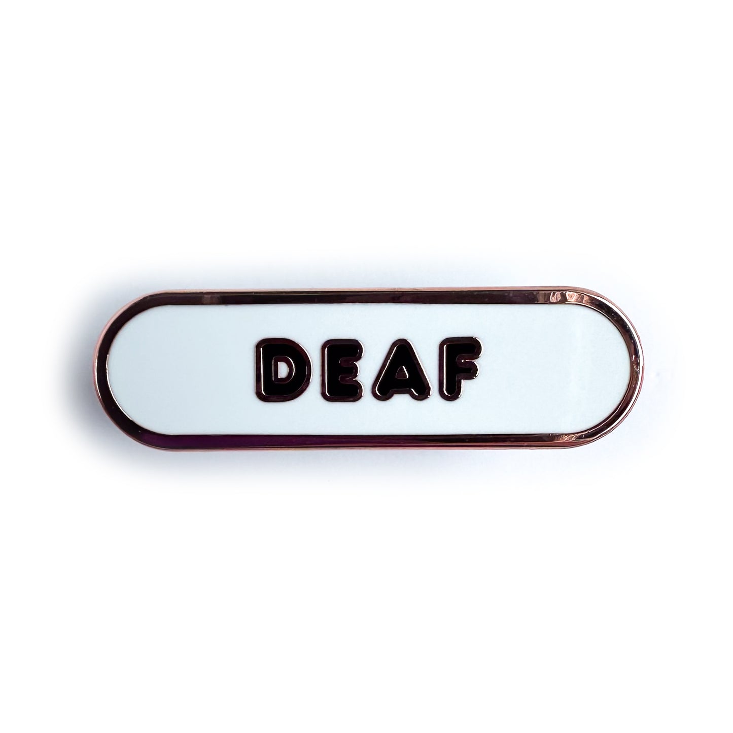 A white oval shaped enamel pin with the word "Deaf" on it in black bubble letters.
