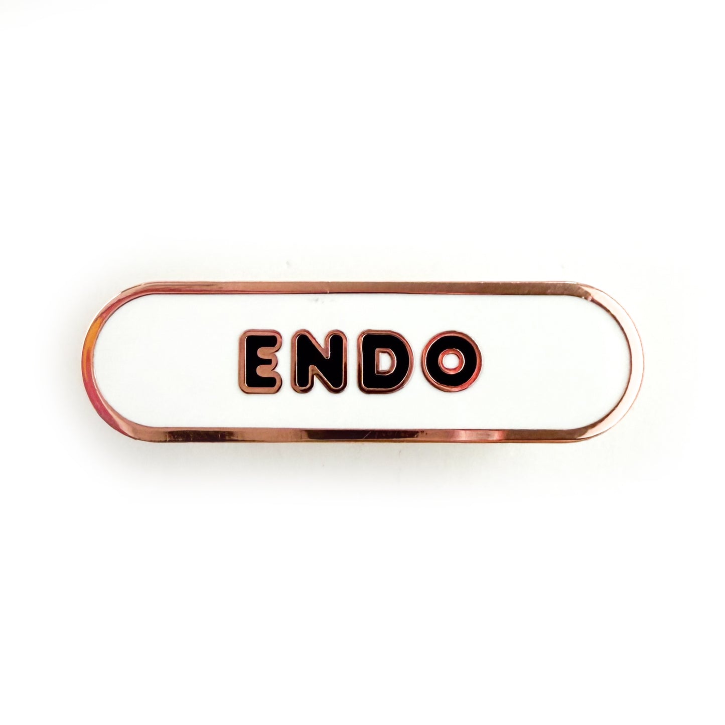 A bandaid shaped pin with the text ENDO in bubble letters. The background is white and the text is black.