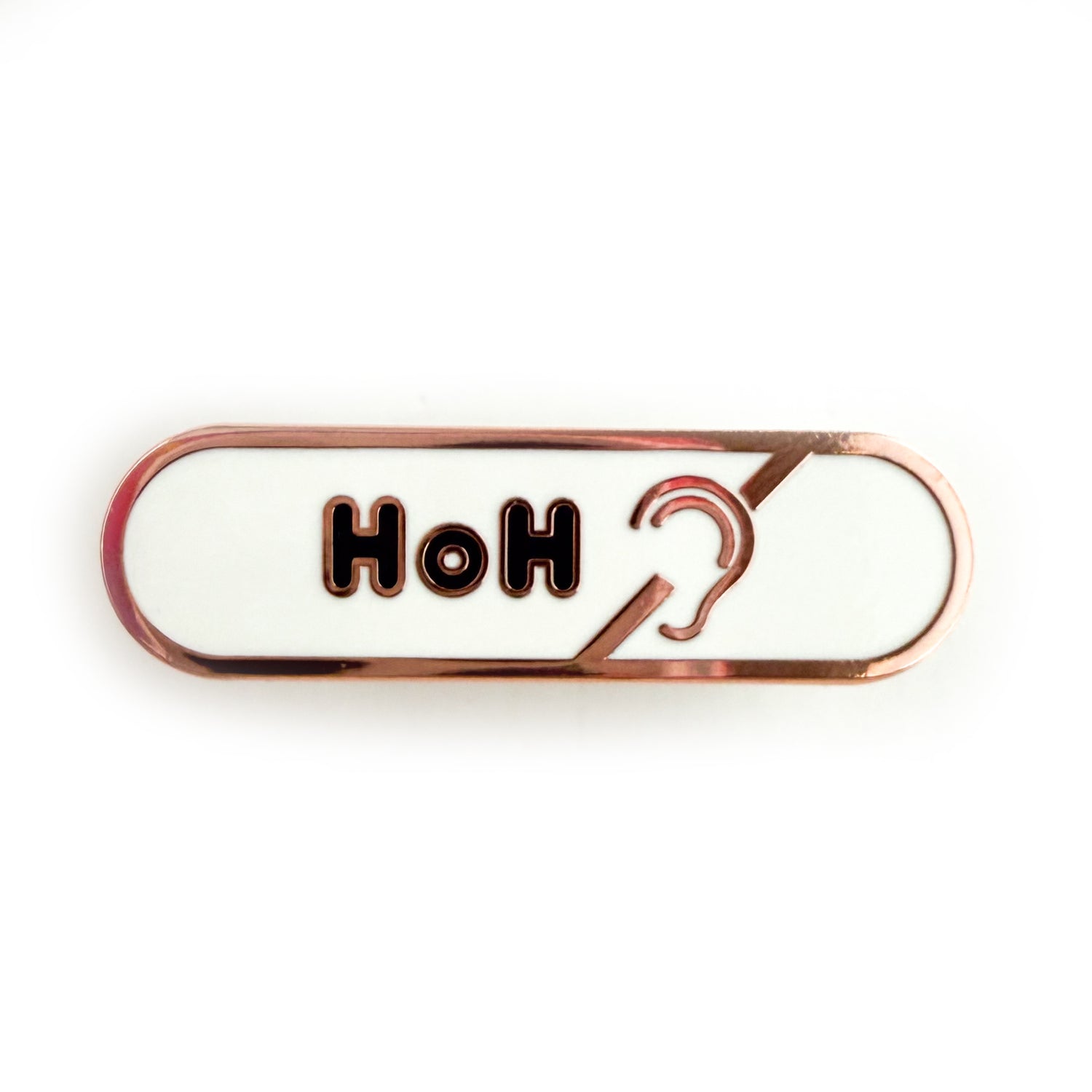 A bandaid shaped pin with the text HoH in bubble letters and the hard of hearing symbol. The background is white and the text is black.