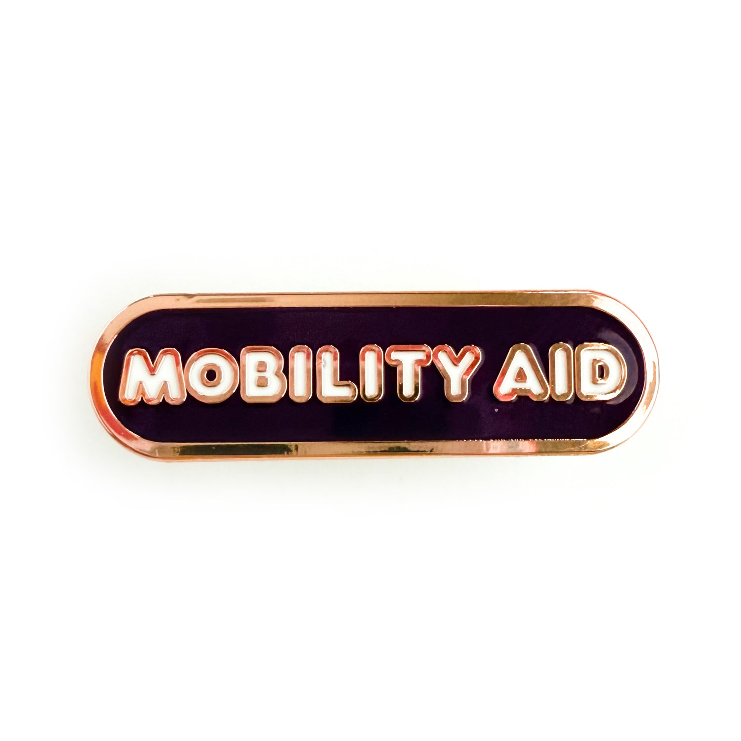 A bandaid shaped pin with the text MOBILITY AID  in bubble letters. The background is dark purple and the text is white.