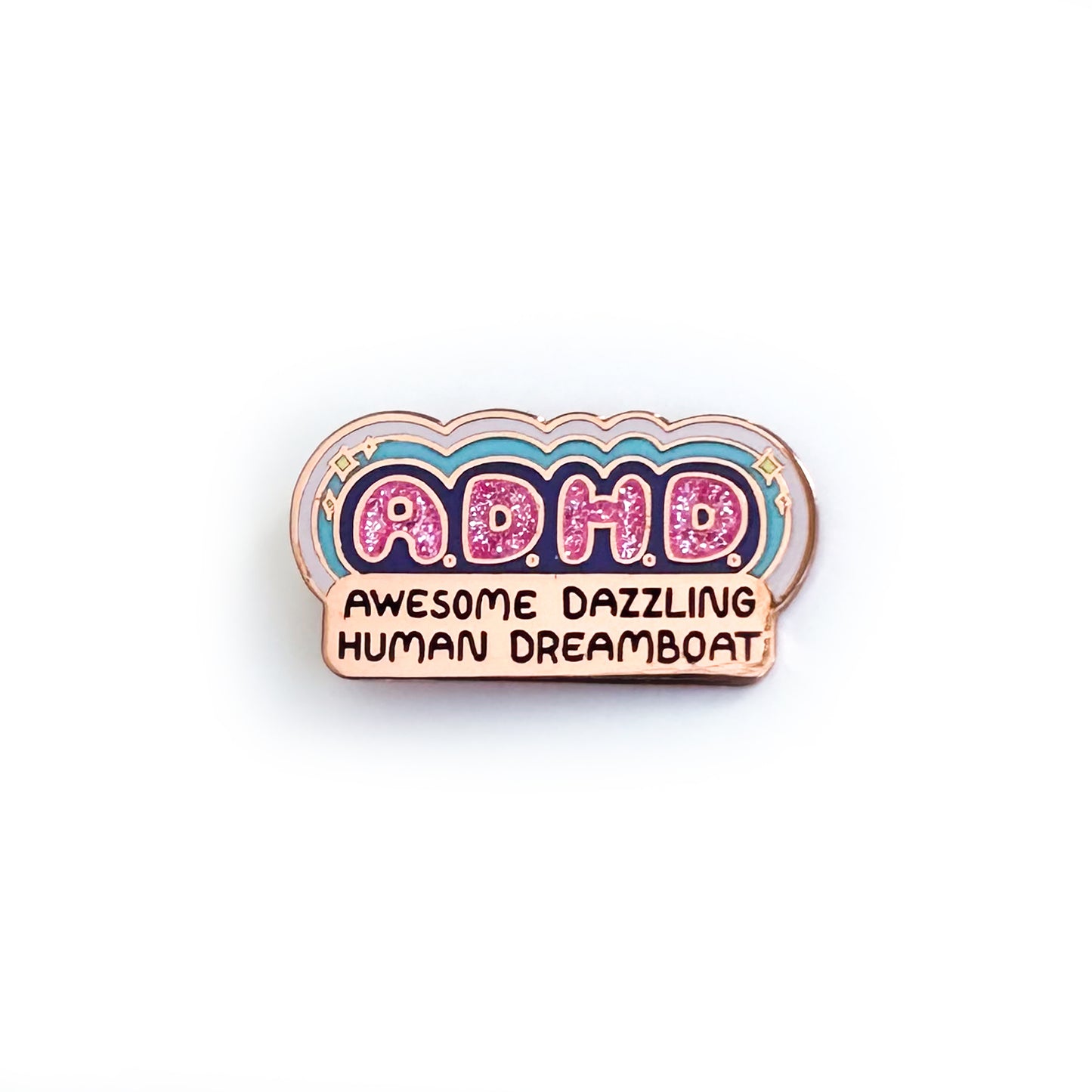An enamel pin that reads "A.D.H.D. Awesome Dazzling Human Dreamboat" the ADHD letters are in sparkly pink enamel bubble letters with colorful rays and sparkles surrounding them.