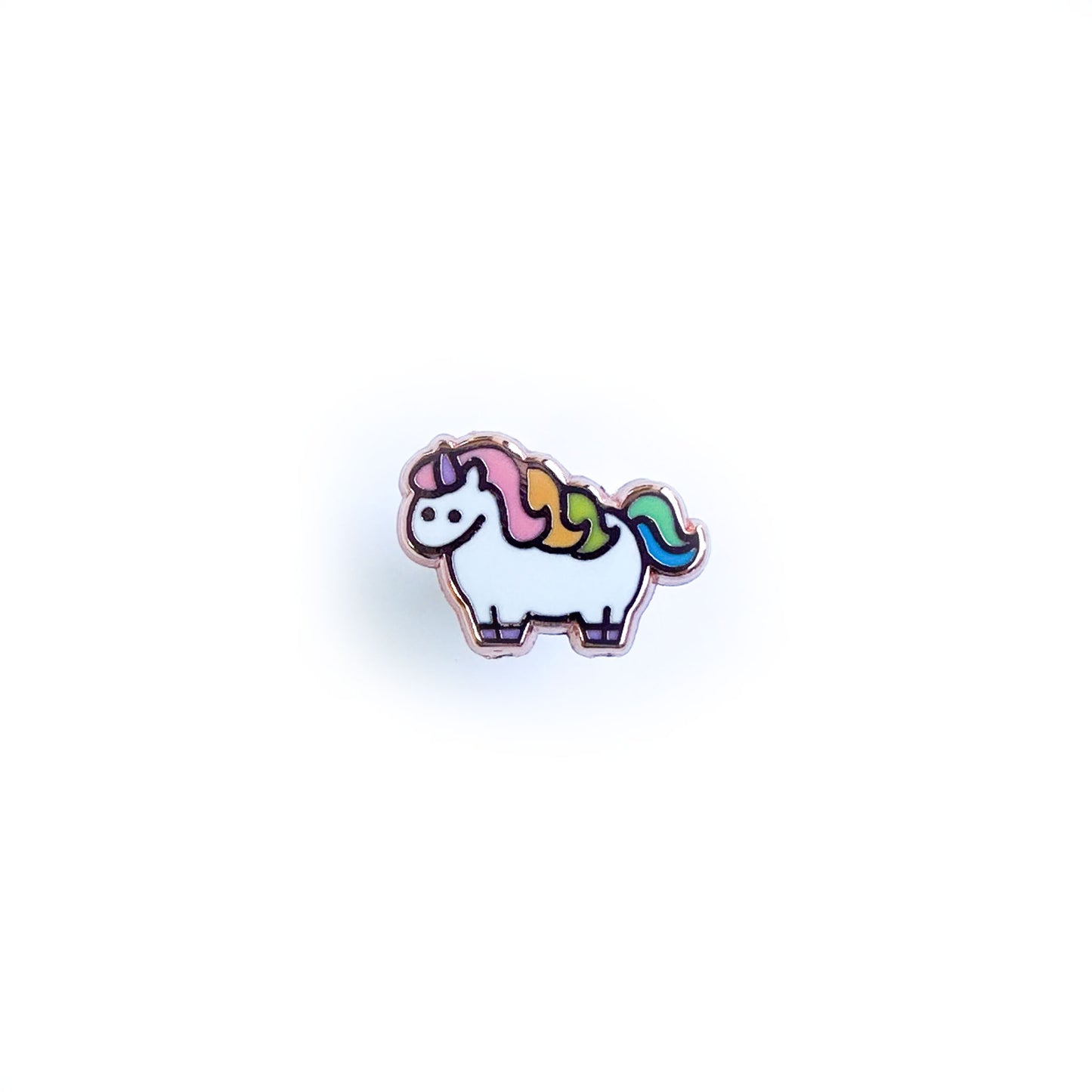 A mini enamel pin shaped like a cute illustration of a chubby unicorn with a pastel rainbow mane and tail.