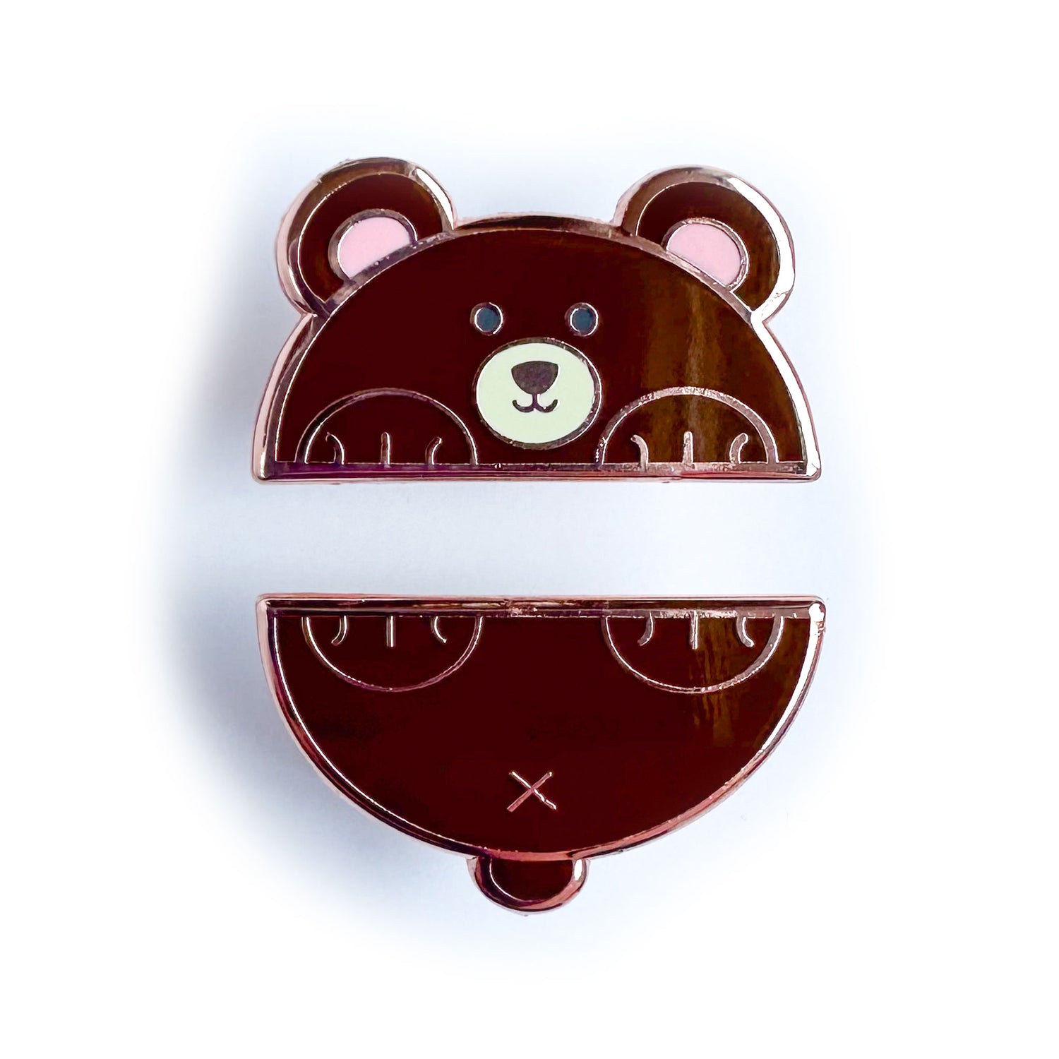 Two enamel pins that come together to form a bear cut in half horizontally. The top pin is the bear's head and front paws and the bottom is his tail and back paws.