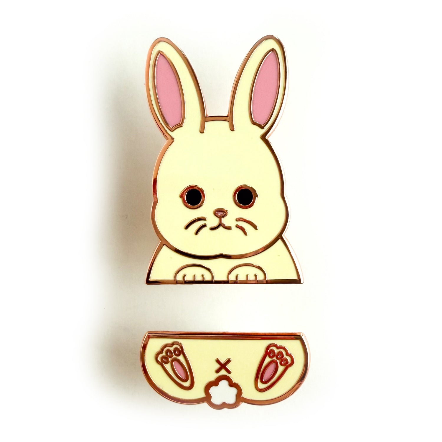 A two piece pin set that comes together to form a white bunny. The top pin is the bunny’s top paws and head with big pink ears. The bottom pin is the bunny’s butt, tail, and feet.