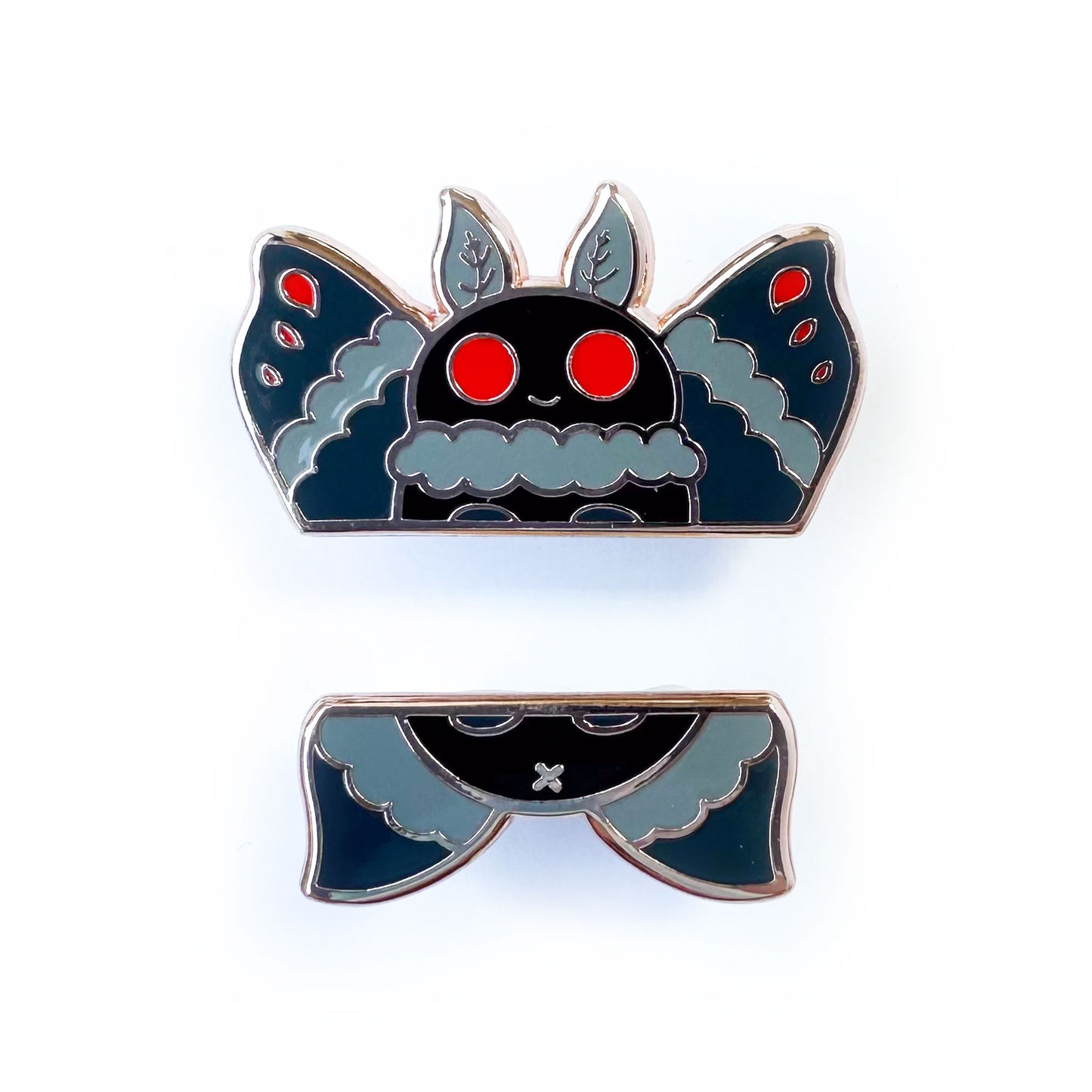 Two enamel pins that come together to form Mothman, one half is the head and wings, the other is the bottom wings and butt.