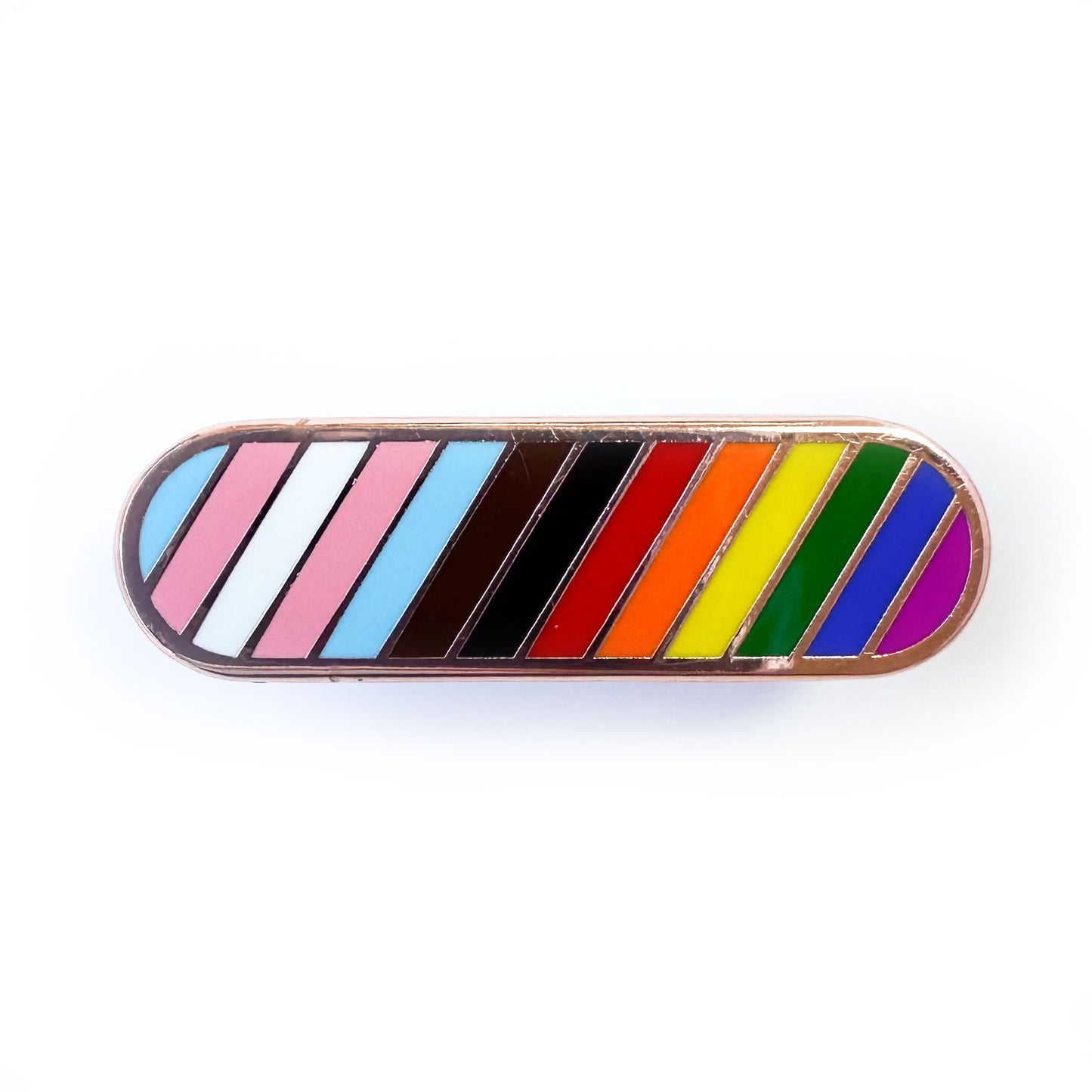 A capsule shaped pin with diagonal stripes in the colors of the progress pride flag.
