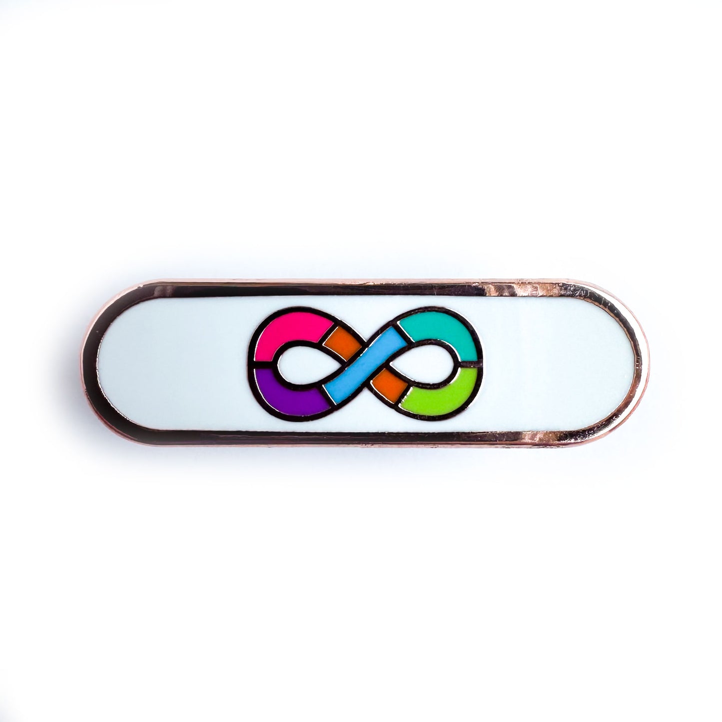 A capsule shaped pin with the rainbow infinity symbol of the neurodivergent pride flag on a white background.