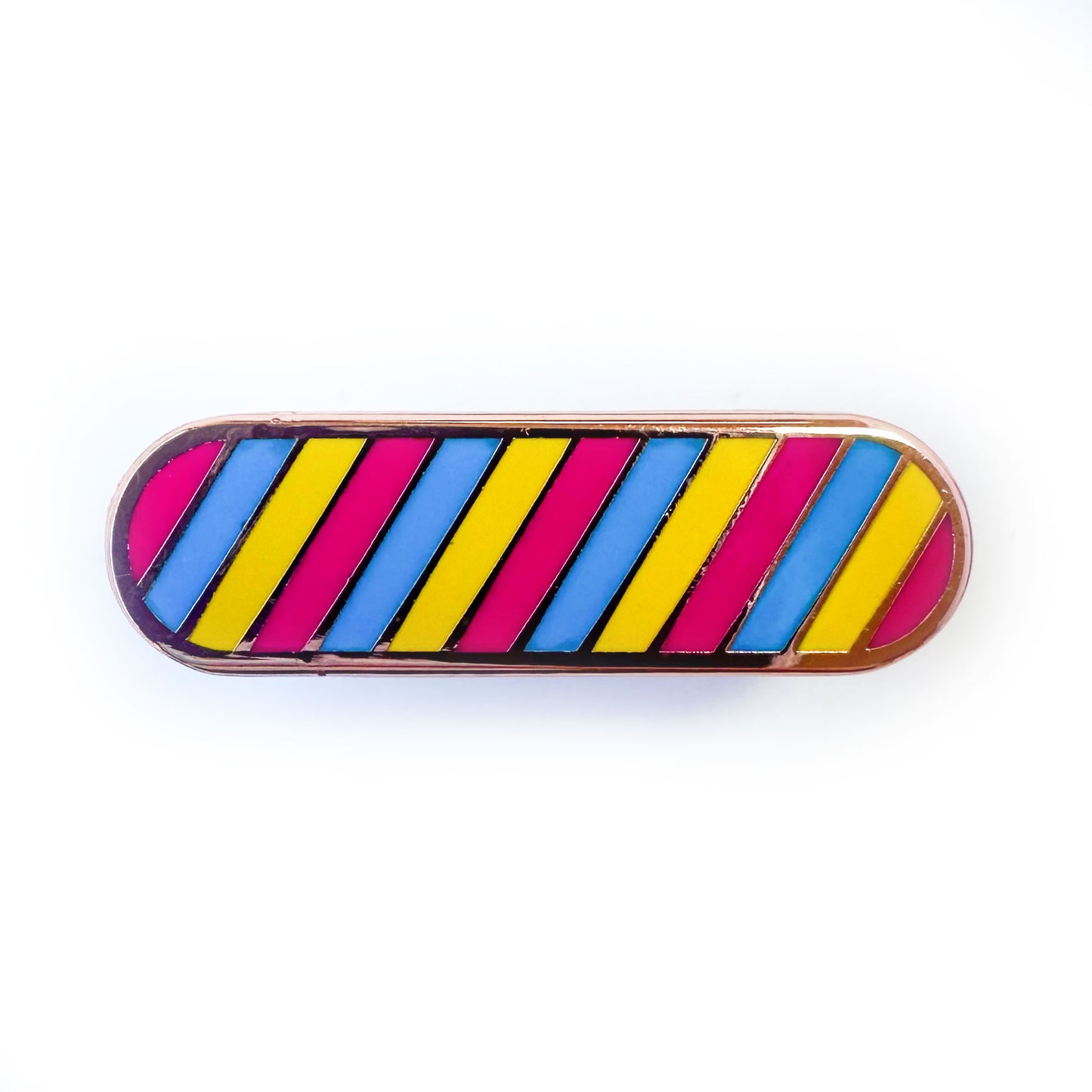 A capsule shaped pin with diagonal stripes in the colors of the Pansexual pride flag, hot pink, blue and yellow.