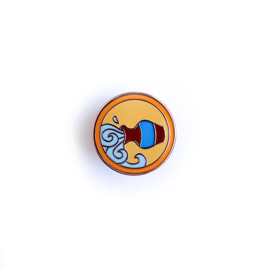 A circular enamel pin depicting a cute version of the symbol for the Aquarius Zodiac sign, a water vessel pouring out flowing water. The background of the pin is yellow with an orange ring around it.