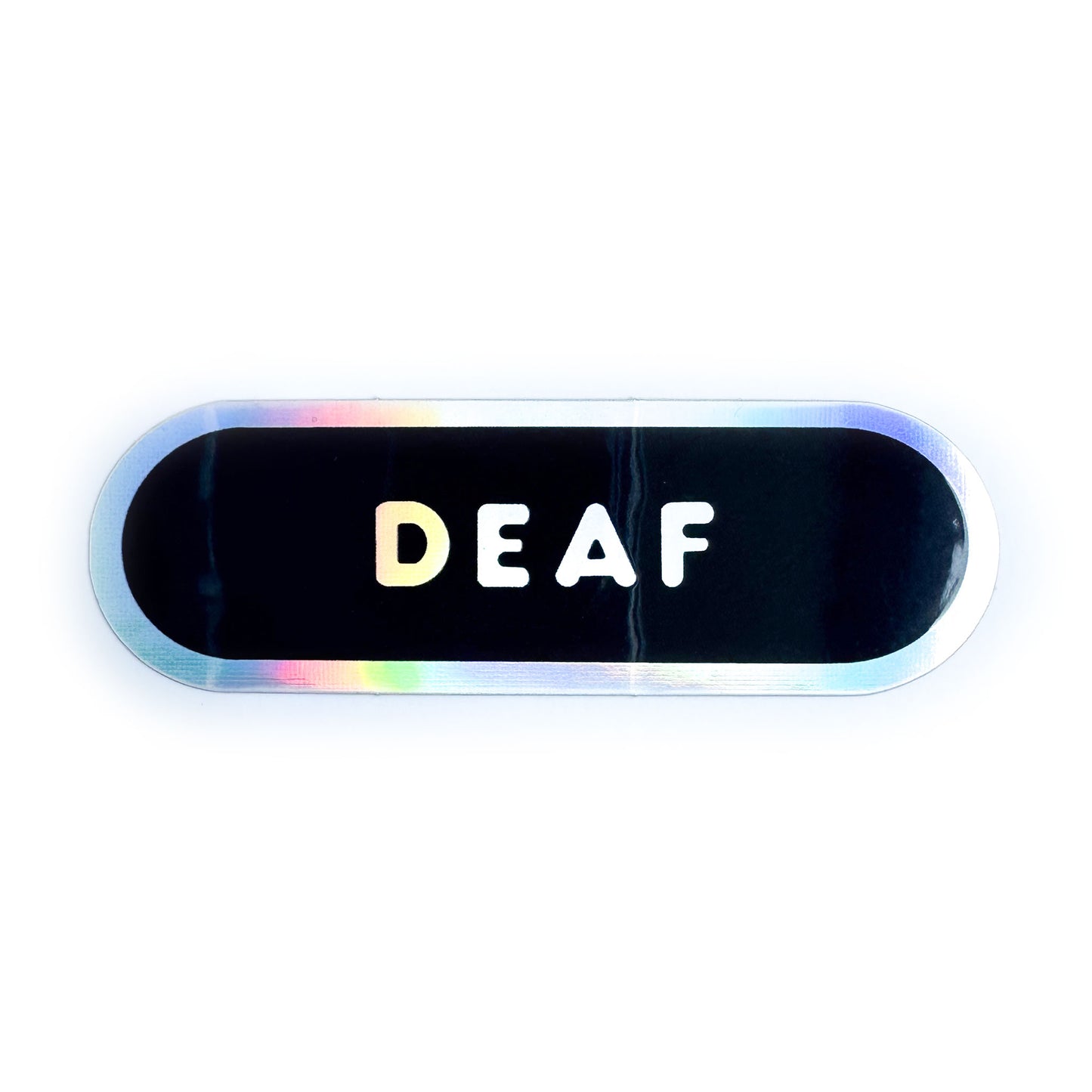 A black capsule shaped sticker with a holographic border and holographic bubble letters that read "Deaf."