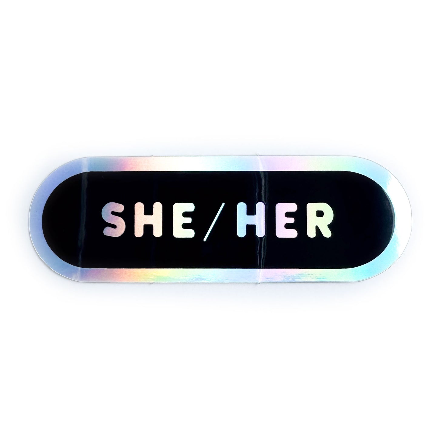 A capsule shaped sticker with the words "She/Her" on it in holographic bubble letters on a black background.