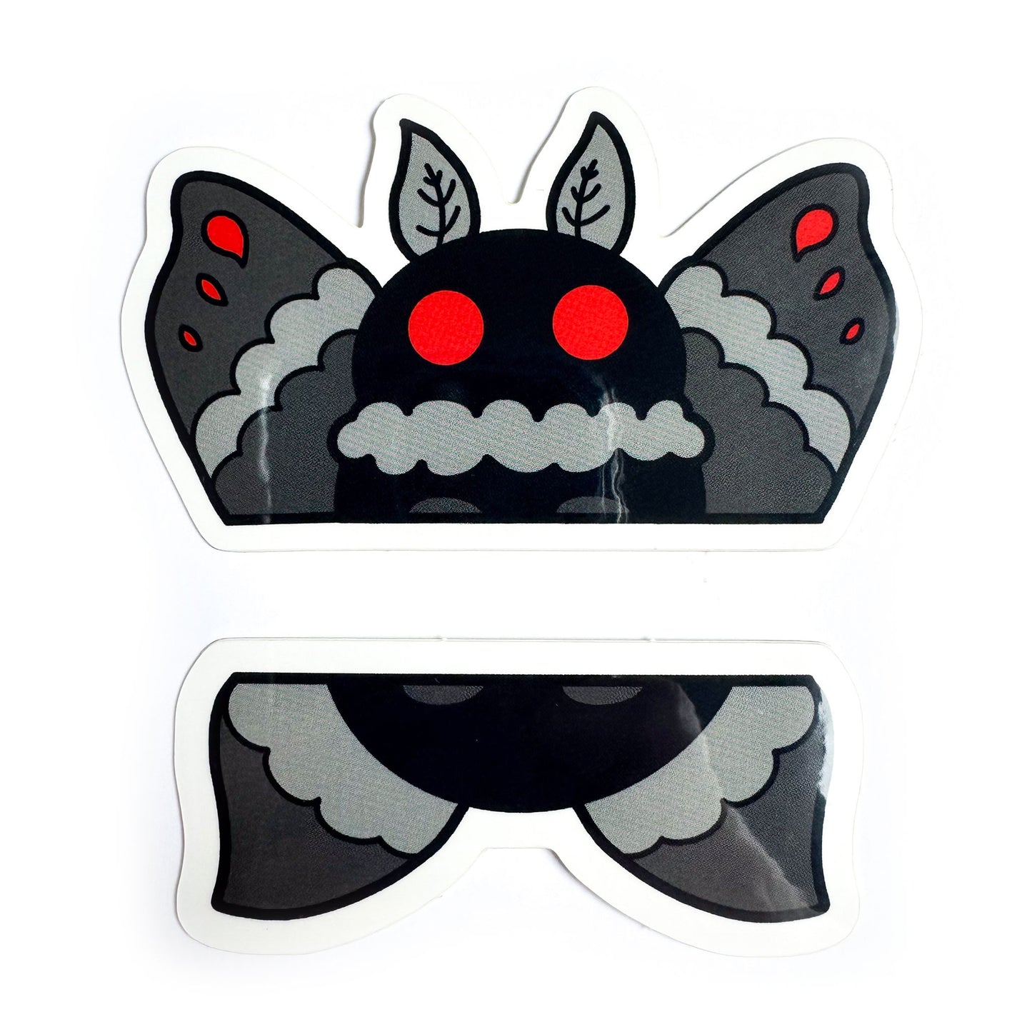 A pair of stickers that come together to form the top and bottom half of Mothman illustrated in a cartoony style with grey wings, a black body, and big red circle eyes.