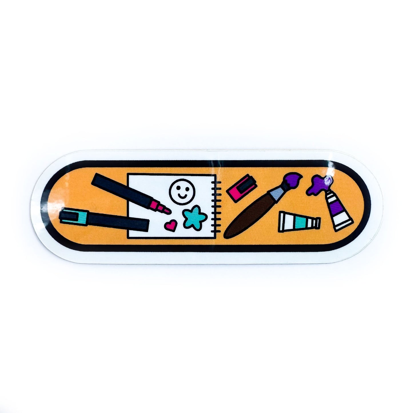 A vinyl sticker in the shape of an oval with illustrations of art supplies like paint pens, paintbrush, paints, and sketchbook on it.