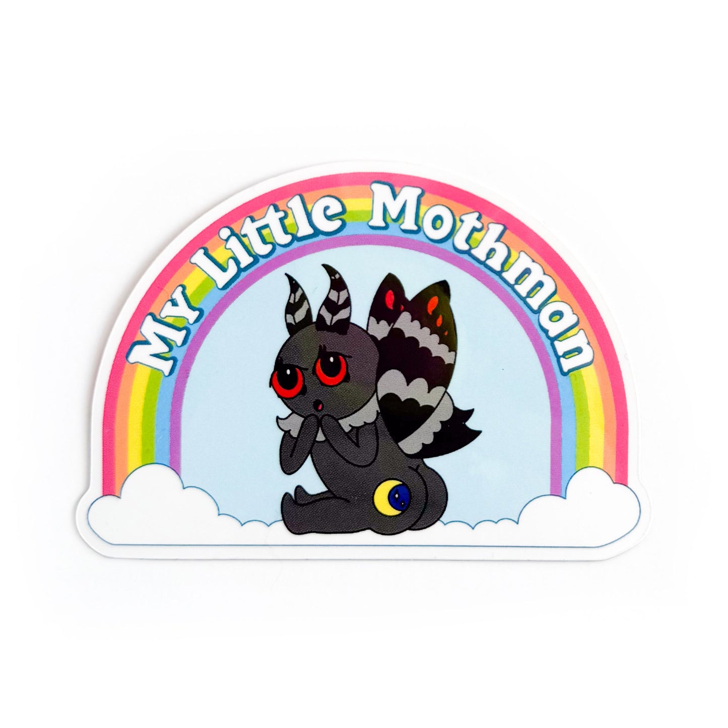 Sticker of a cartoon illustration of mothman turned with his butt towards you, his butt has a moon on one cheek. Above mothman is a rainbow with the words "My Little Mothman"
