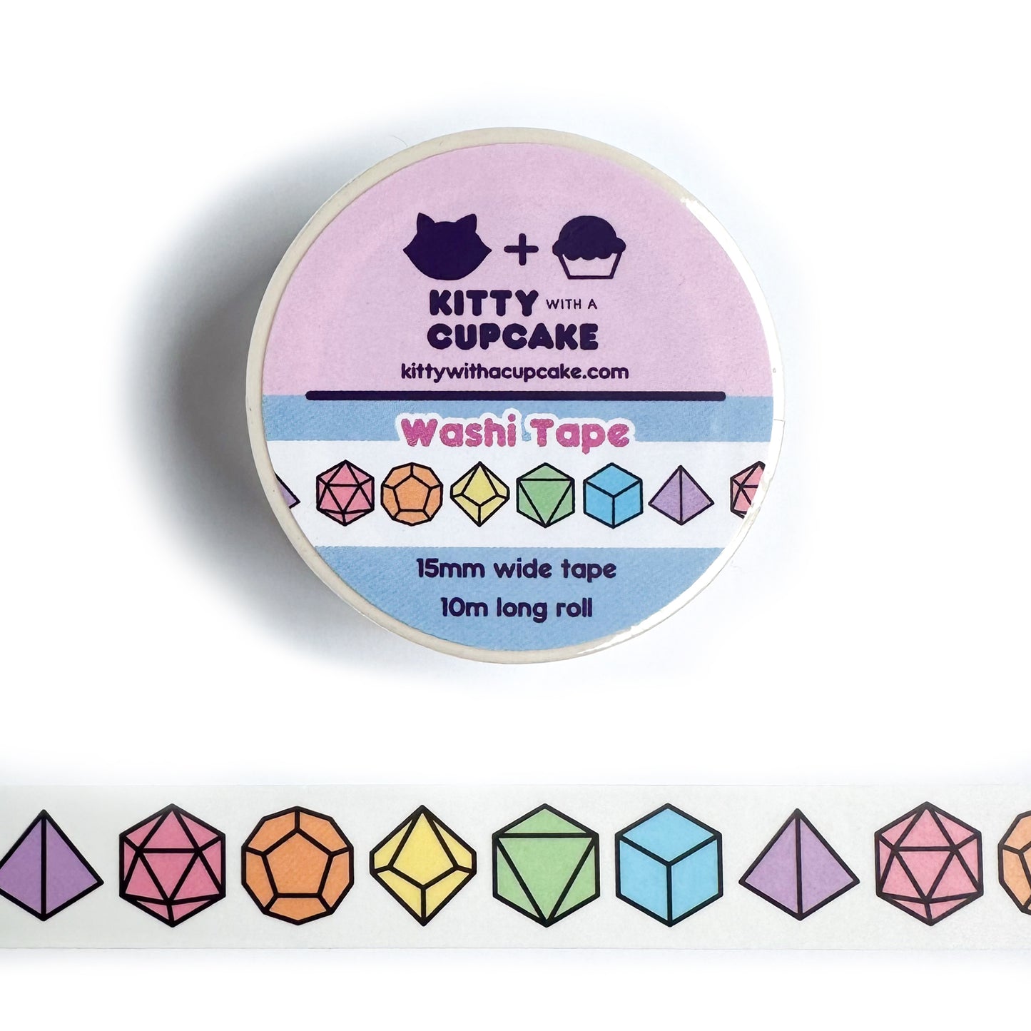 A roll of washi tape with pastel rainbow illustrations of rainbow polyhedral dice on it. There is a pice of the tape stuck below the roll.