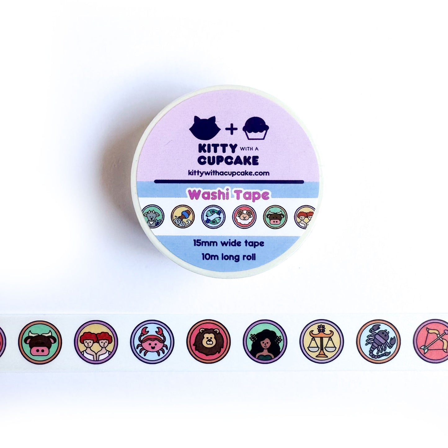 A roll of washi tape above a piece of the same tape. The tape has circles on it with symbols for each zodiac sign in a cute illustration style.