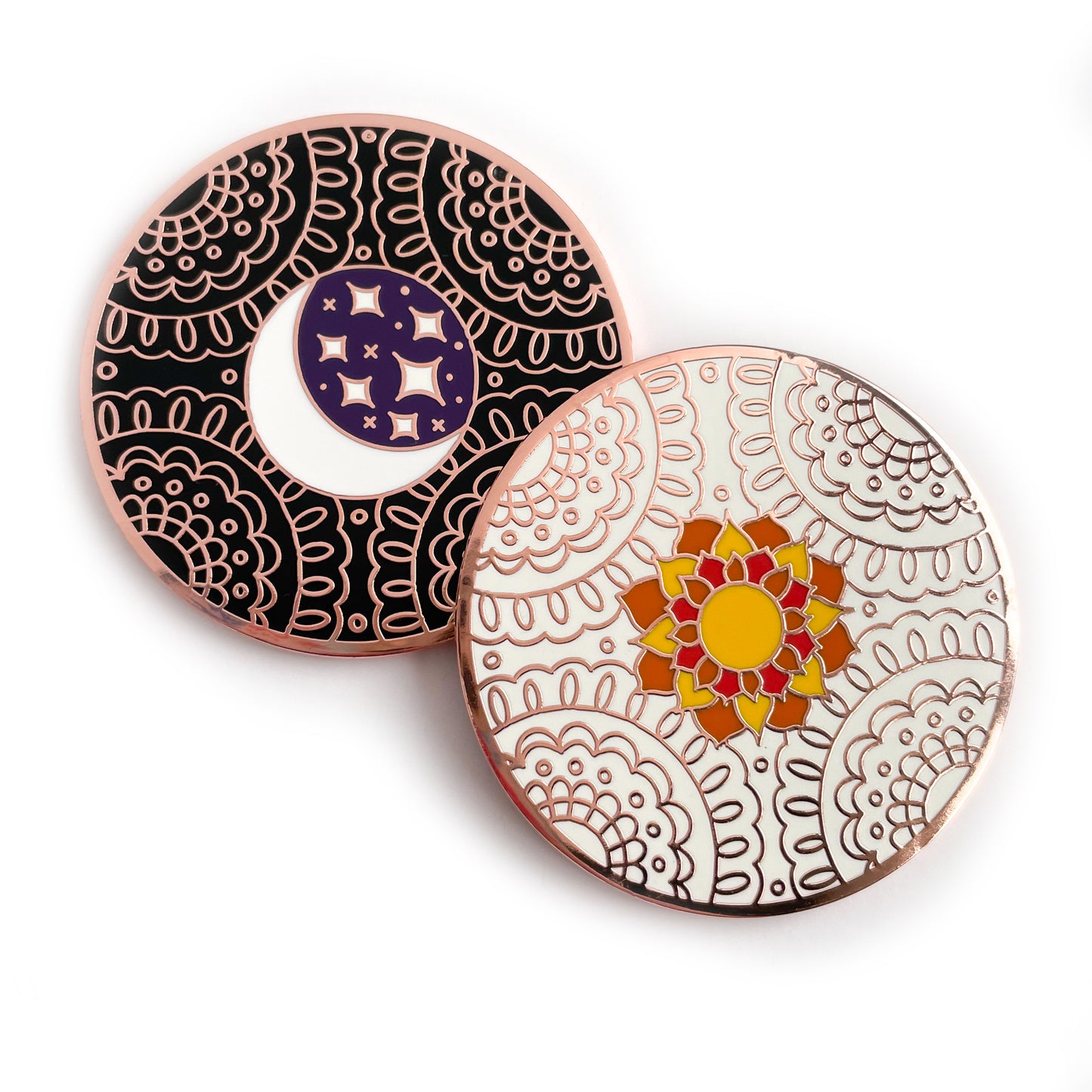 A coin with a sun on a white lace background resting on a coin with a moon and stars on a black lace background.