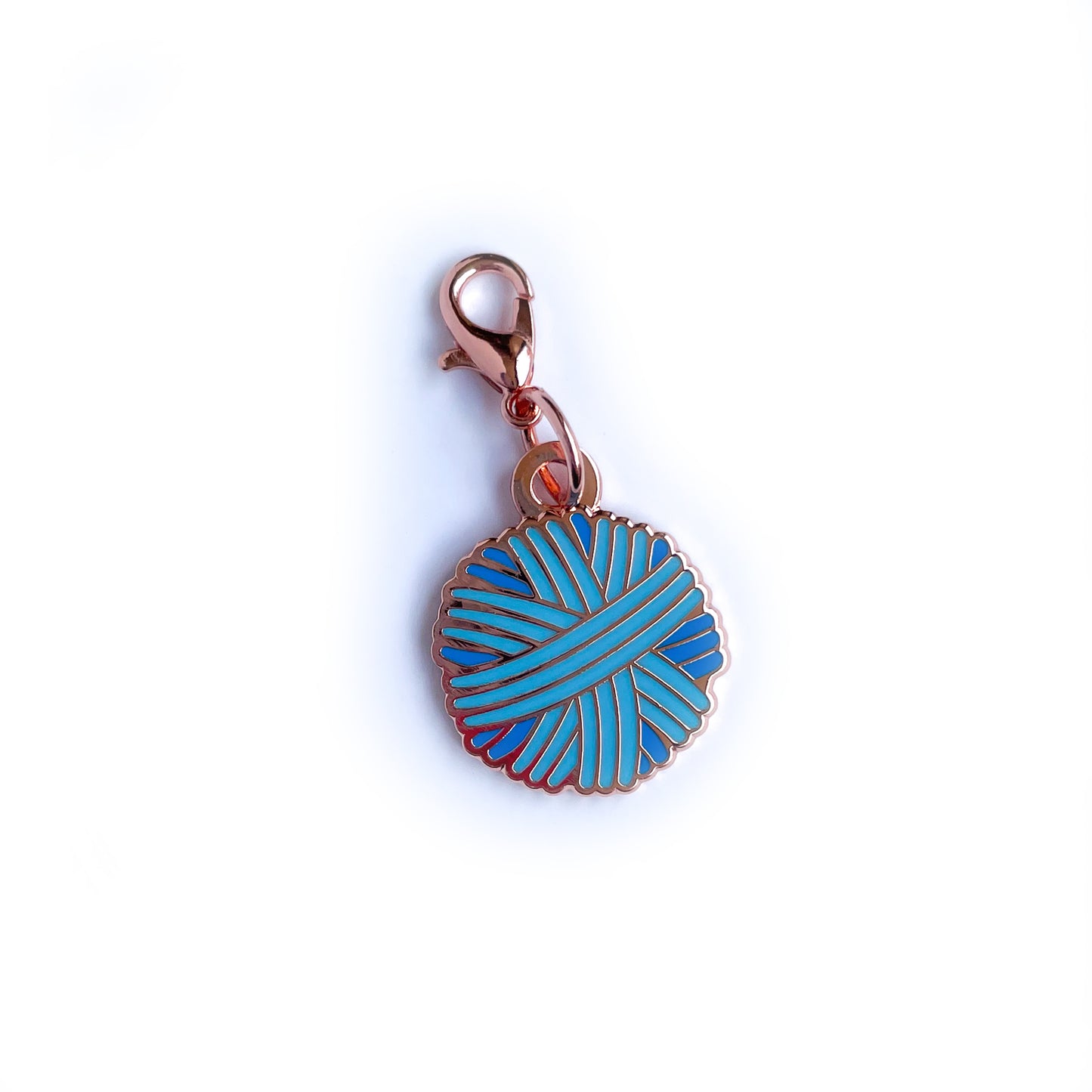 A pastel blue yarn ball charm.