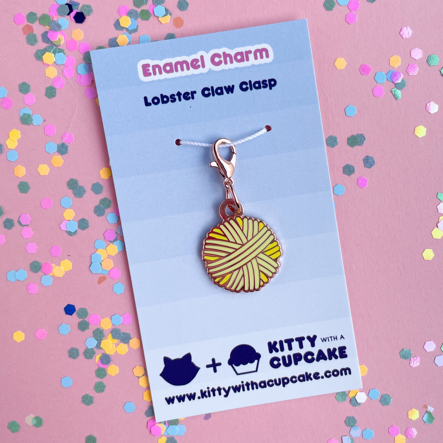 An yellow yarn ball on a blue card.