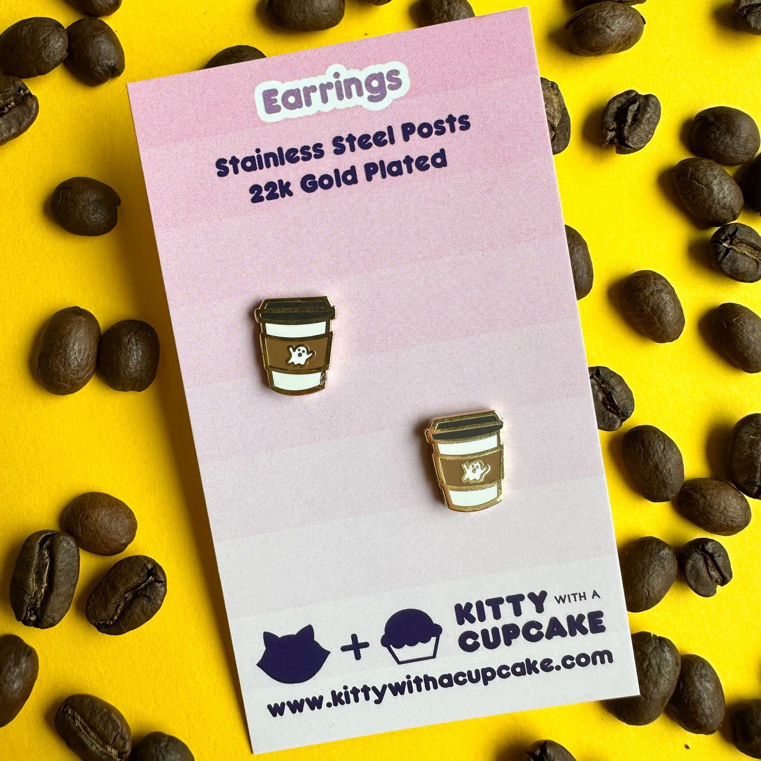 Ghost coffee cup earrings packaged on a pink card 