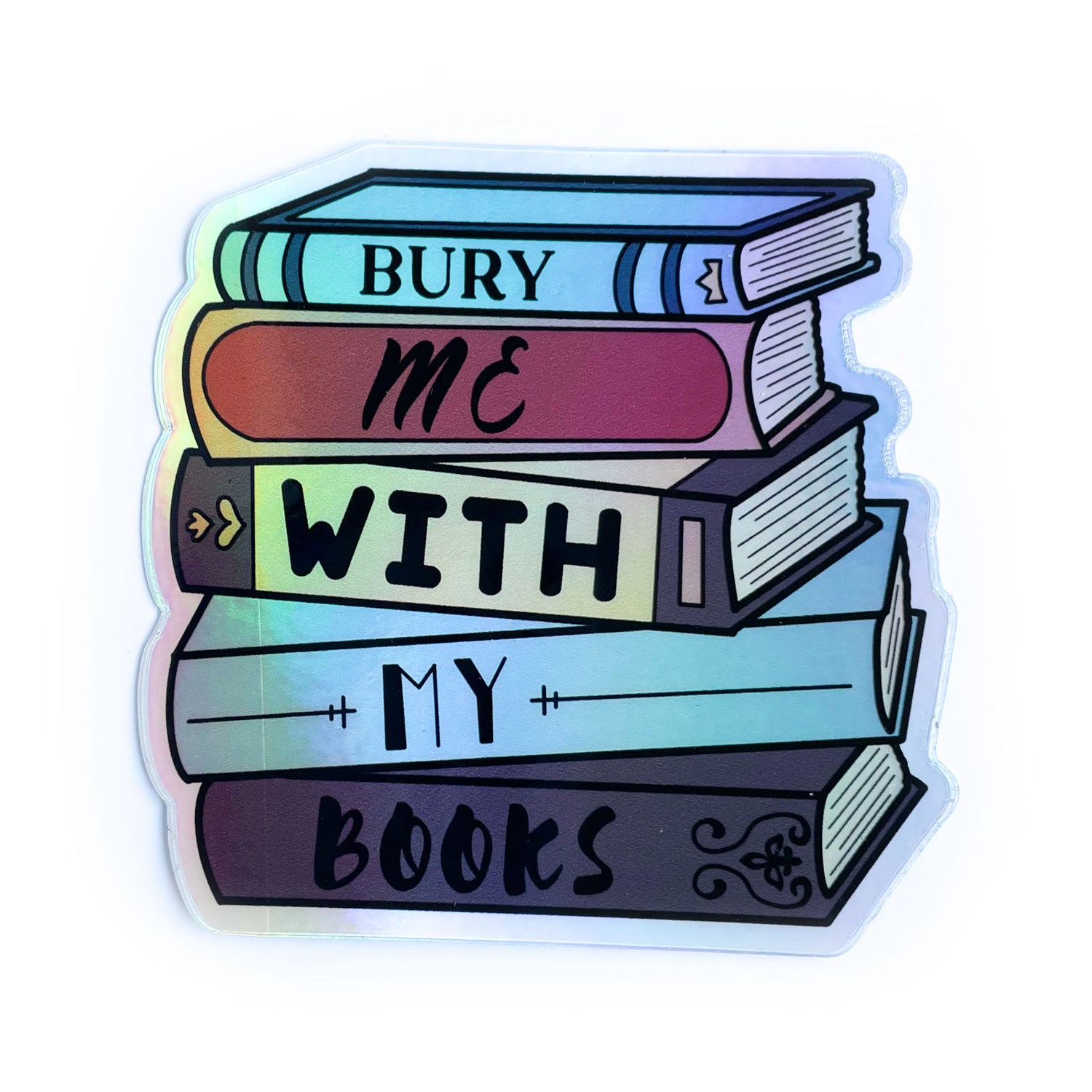 A sticker shaped like a stack of books that reads "Bury me with my books"