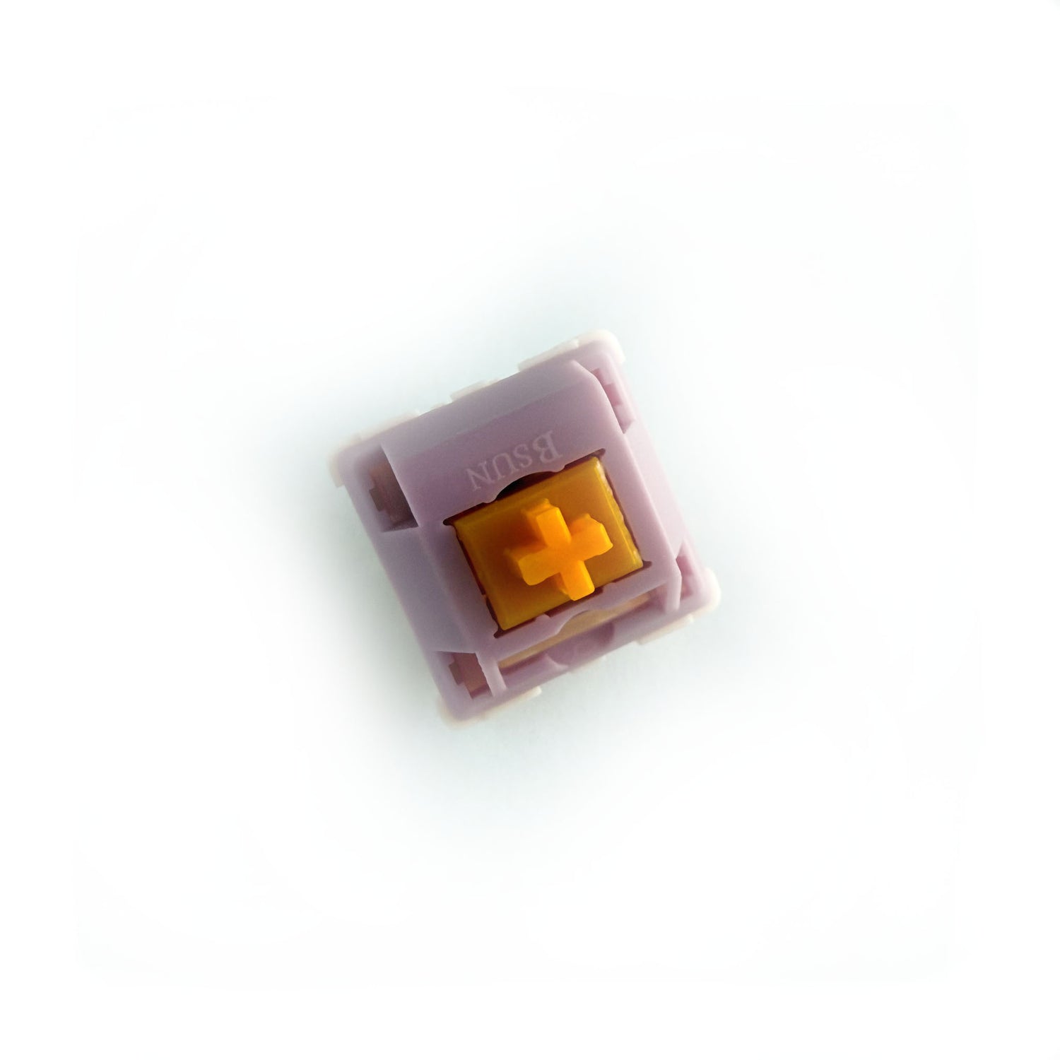 A linear keyboard switch on a white background. The switch component is orange, the casing is purple.