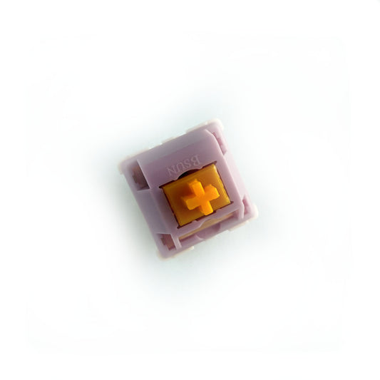 A linear keyboard switch on a white background. The switch component is orange, the casing is purple.