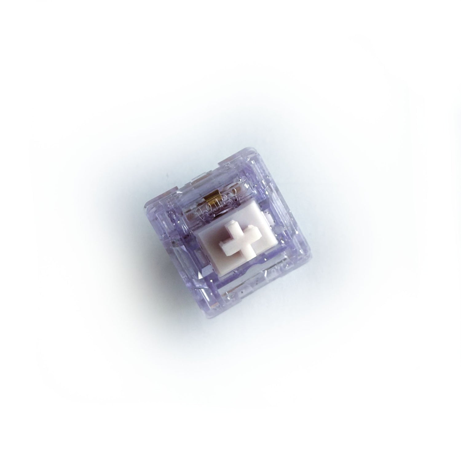 A linear keyboard switch on a white background. The switch component is white, and the casing is a translucent purple with sparkles.