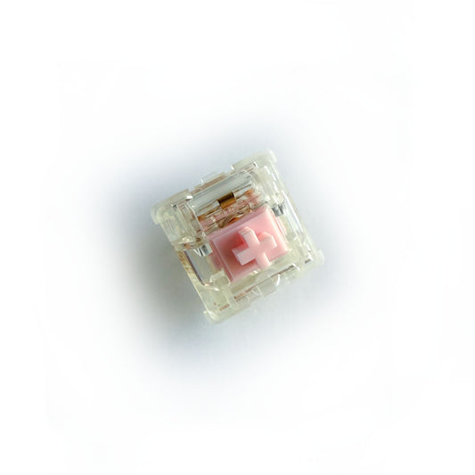 A tactile keyboard switch on a white background. The switch component is light pink, the casing is clear. 