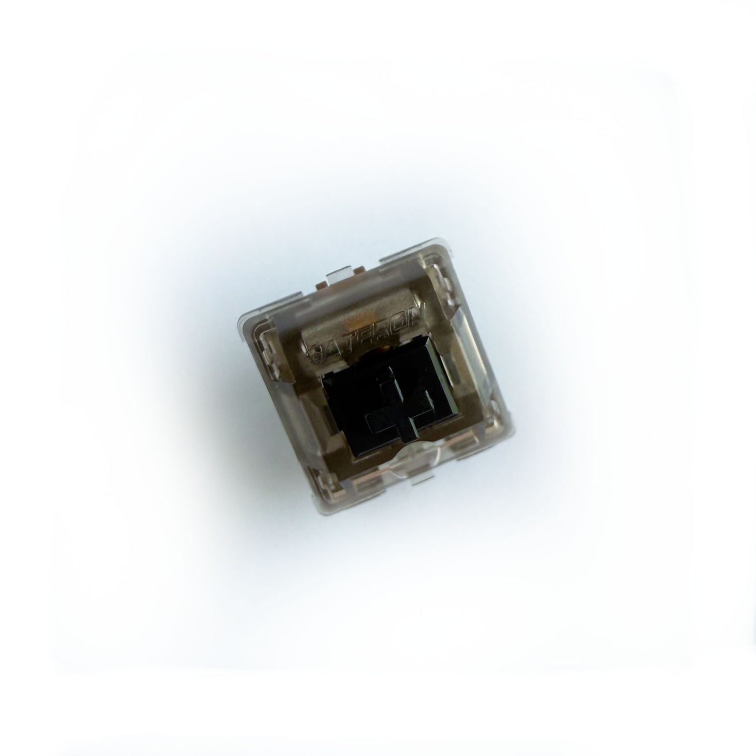 A linear keyboard switch on a white background. The switch component is black, and the casing is a translucent black with the word "GATERON" imprinted into it.