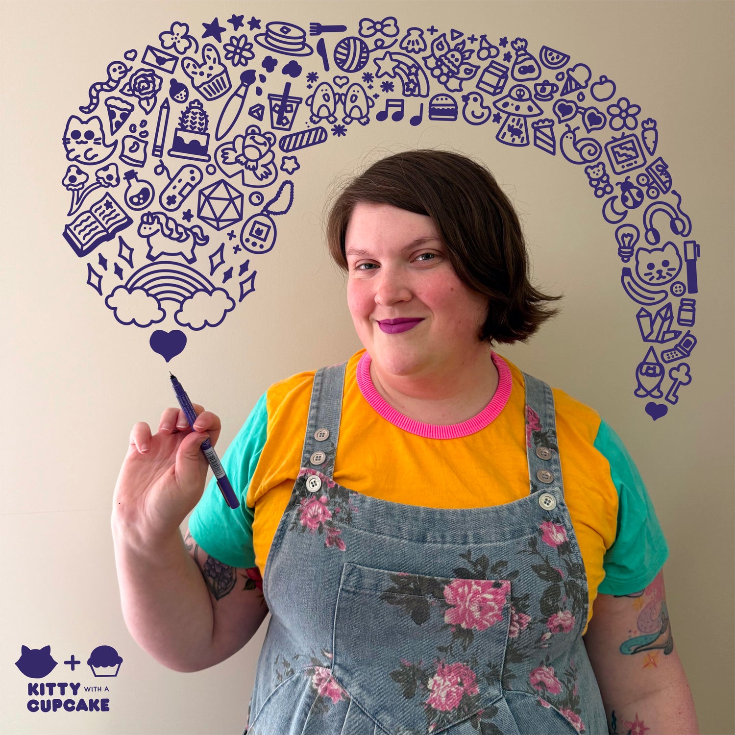A picture of Emily, a midsize white woman with an asymmetrical haircut with brown hair. She is wearing denim overalls with pink flowers over a yellow t-shirt with aqua sleeves and a pink collar. Emily is holding a purple pen up and cute purple doodles appear to be coming out of the pen. The doodles have a cute unicorn, cactus, video game controller, duck, alien ufo, cat, and cute fruits. 