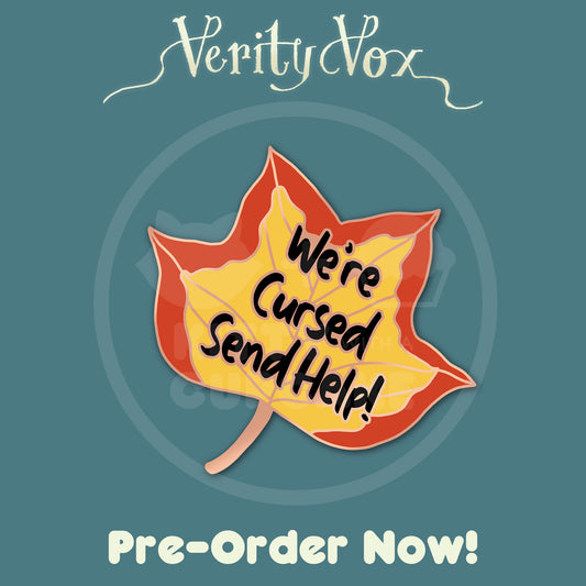 A mock up of an enamel pin shaped like a tulip poplar leaf with the words "We're Cursed Send Help!" written on it. Above the leaf are the words "Verity Vox" in the same flowy text as thh title of the book. Below the leaf are the words "Pre-Order Now!"