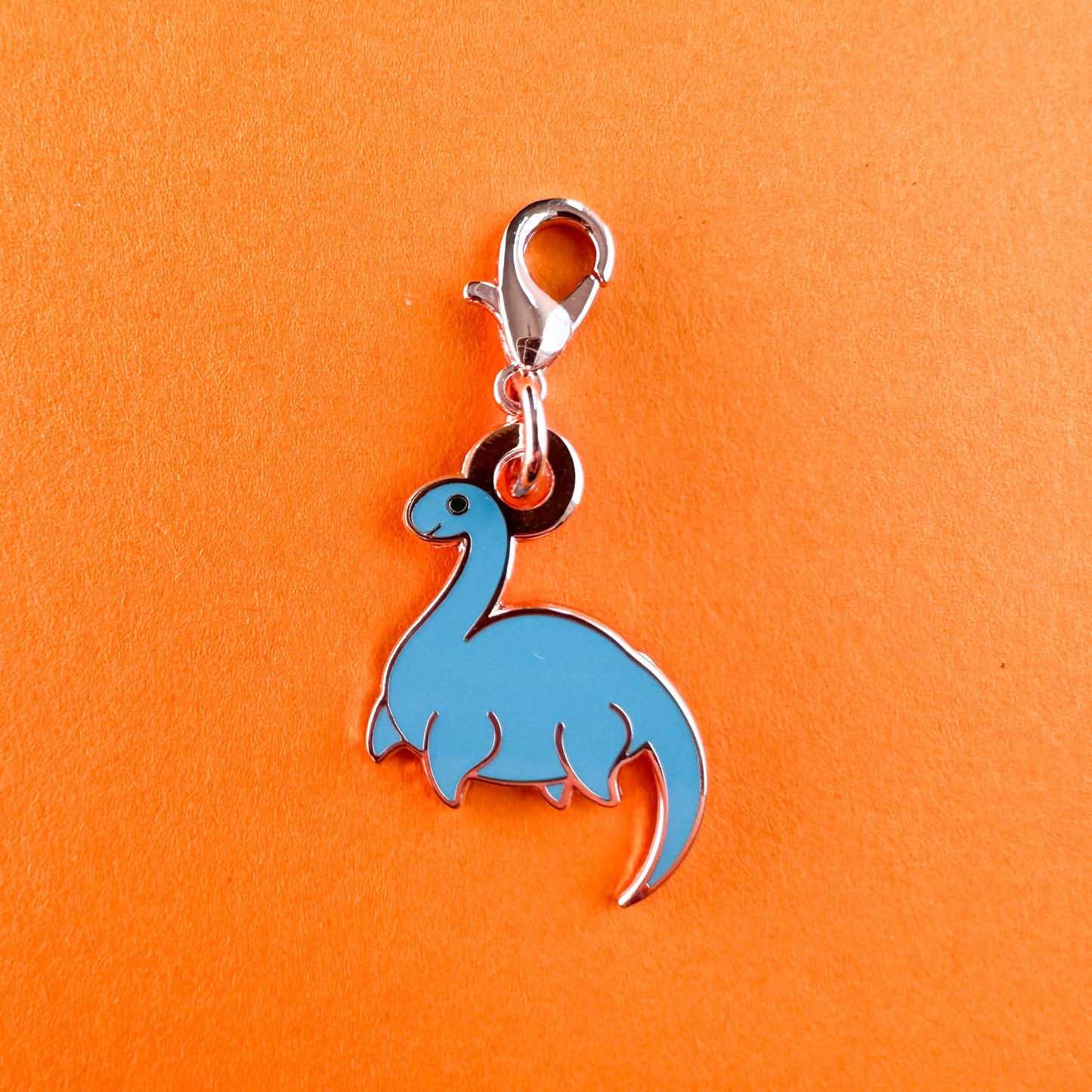 A charm in the shape of Nessie with a lobster claw clasp. 