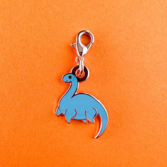 A charm in the shape of Nessie with a lobster claw clasp.