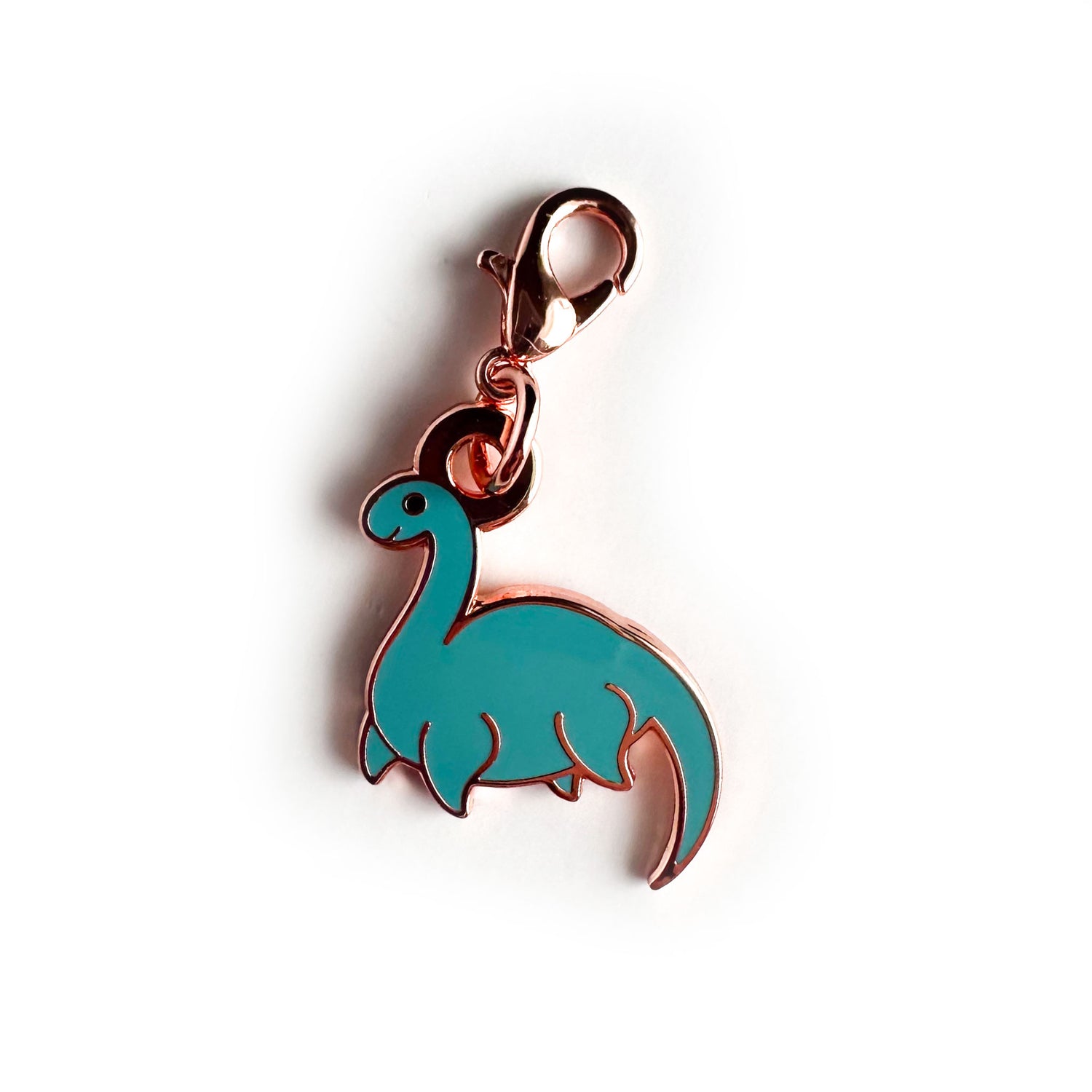 A charm in the shape of the Loch Ness monster with a lobster claw clasp. 