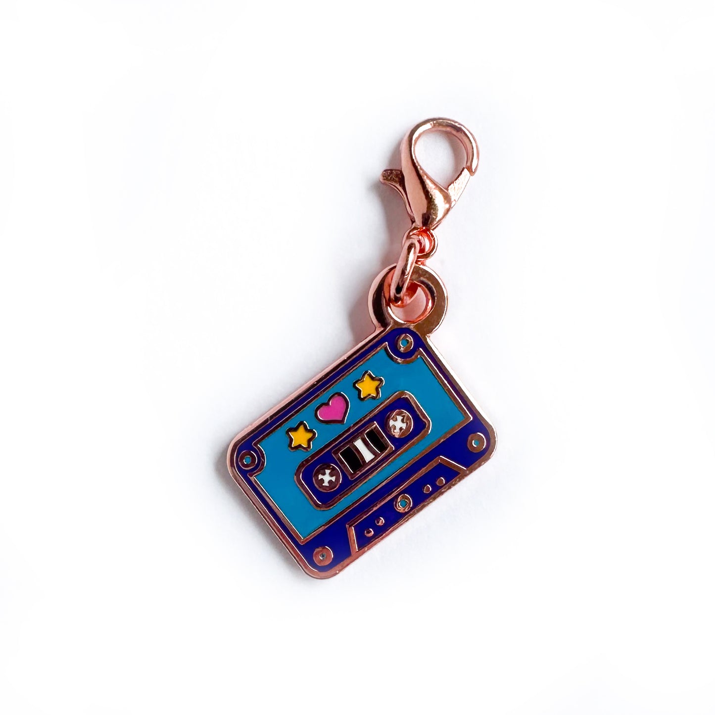 A lobster claw clasp charm of a purple and teal cassette tape