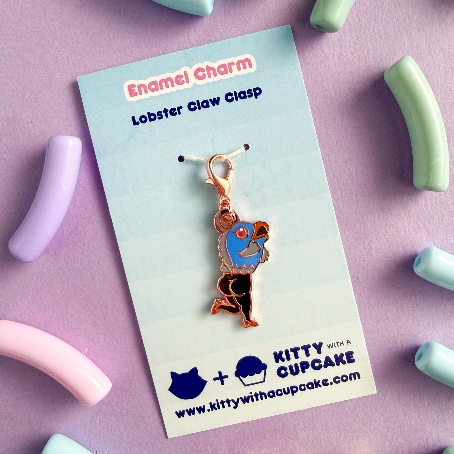 The Blue Reverse Mermaid charm is packaged on a blue card that reads "Enamel Charm Lobster Claw Clasp" and has the Kitty With a Cupcake logo on it. 