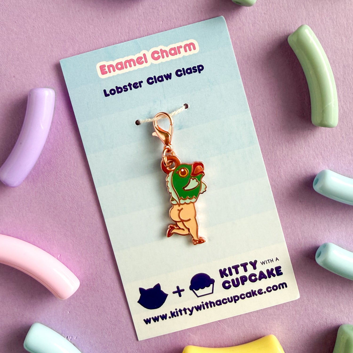 The Teal Reverse Mermaid charm is packaged on a blue card that reads "Enamel Charm Lobster Claw Clasp" and has the Kitty With a Cupcake logo on it. 