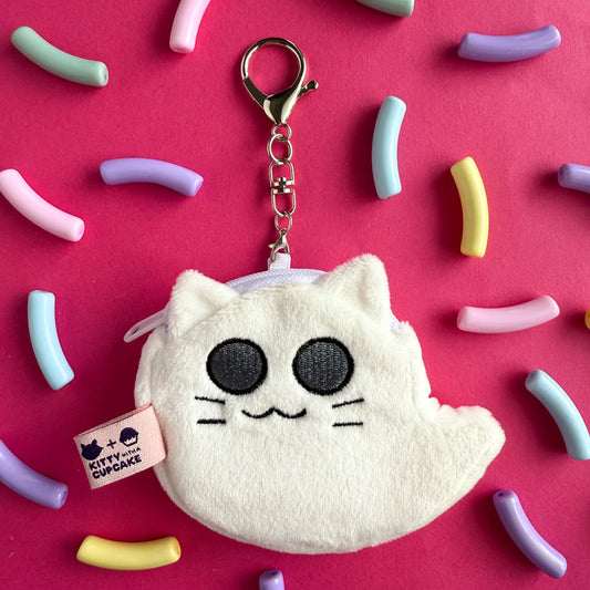 A Ghost Kitty coin purse displayed on a hot pink background with rainbow noodle shaped beads.
