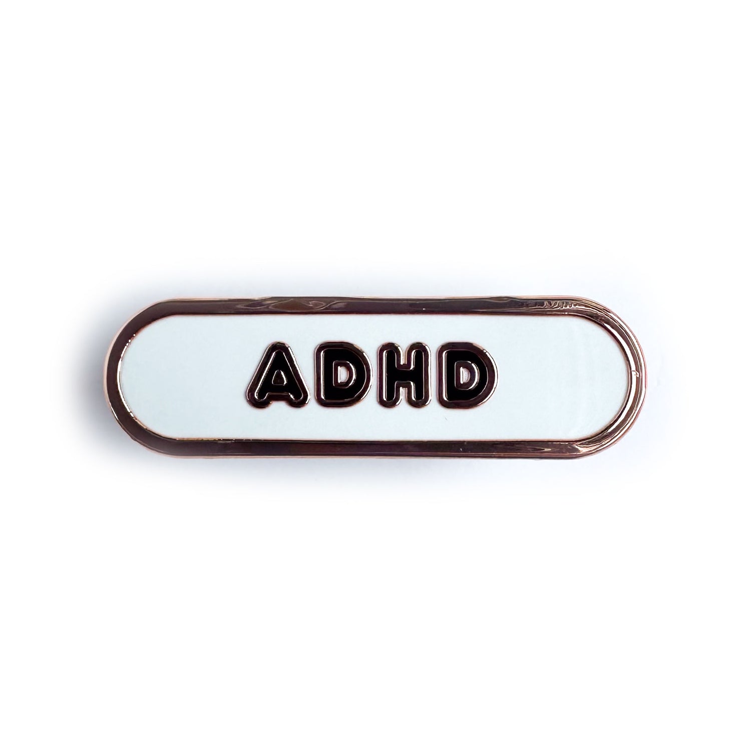 A white enamel pin with the letters ADHD on it in black bubble letters.