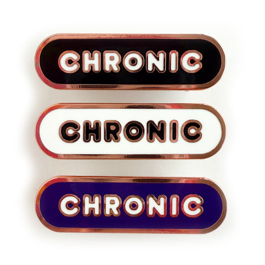 Three bandaid shaped pins with the text CHRONIC in bubble letters. Top one black with white text, the next is white with black text, and the last is navy blue with white text.