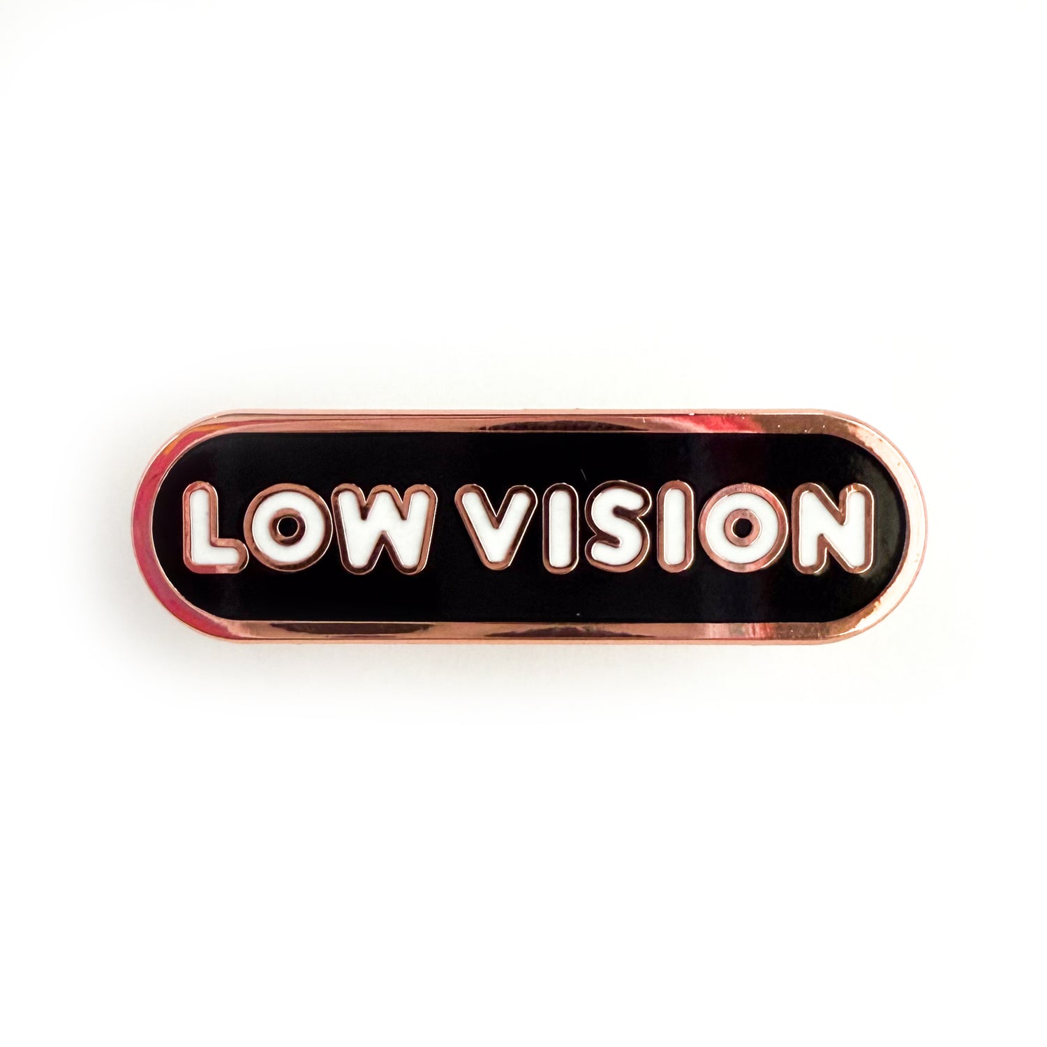 A bandaid shaped pin with the text LOW VISION  in bubble letters. The background is black and the text is white.