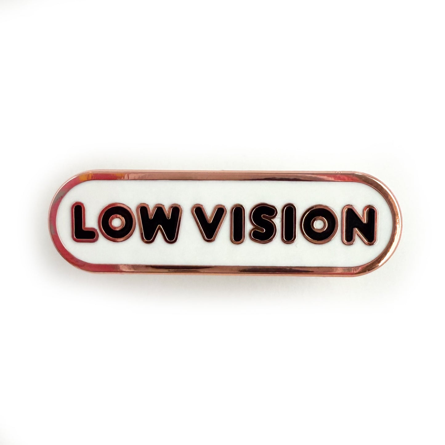 A bandaid shaped pin with the text LOW VISION  in bubble letters. The background is white and the text is black.