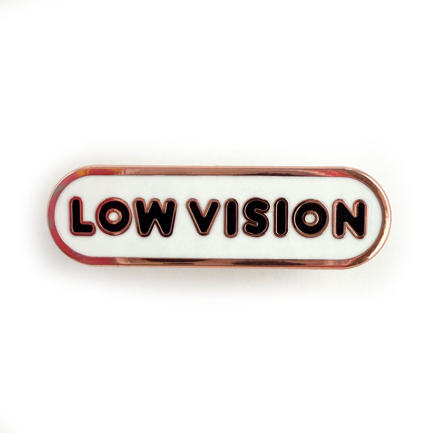 A bandaid shaped pin with the text LOW VISION  in bubble letters. The background is white and the text is black.