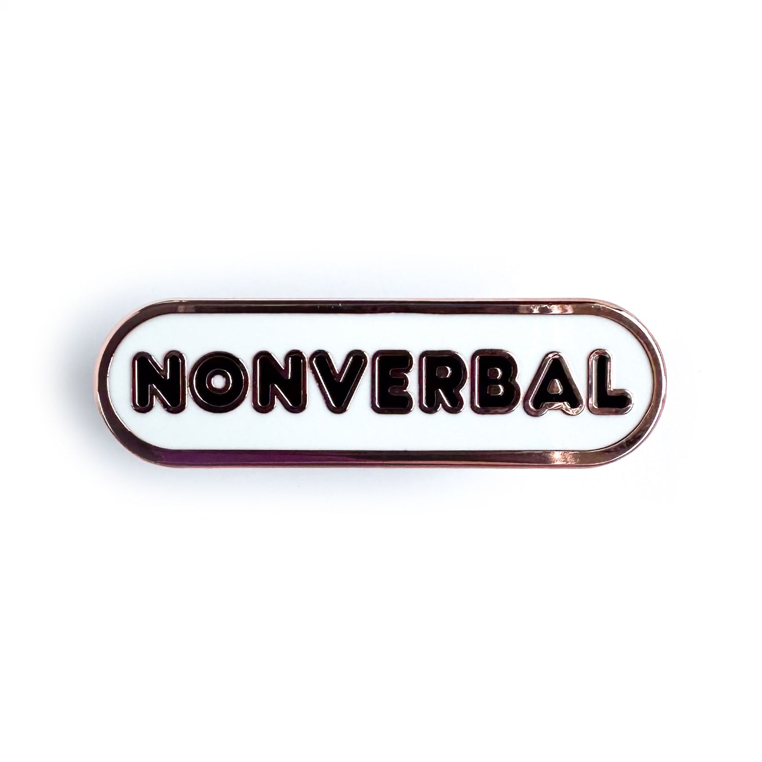 A white enamel pin in the shape of a bandaid that has black bubble letters that spell "Nonverbal".