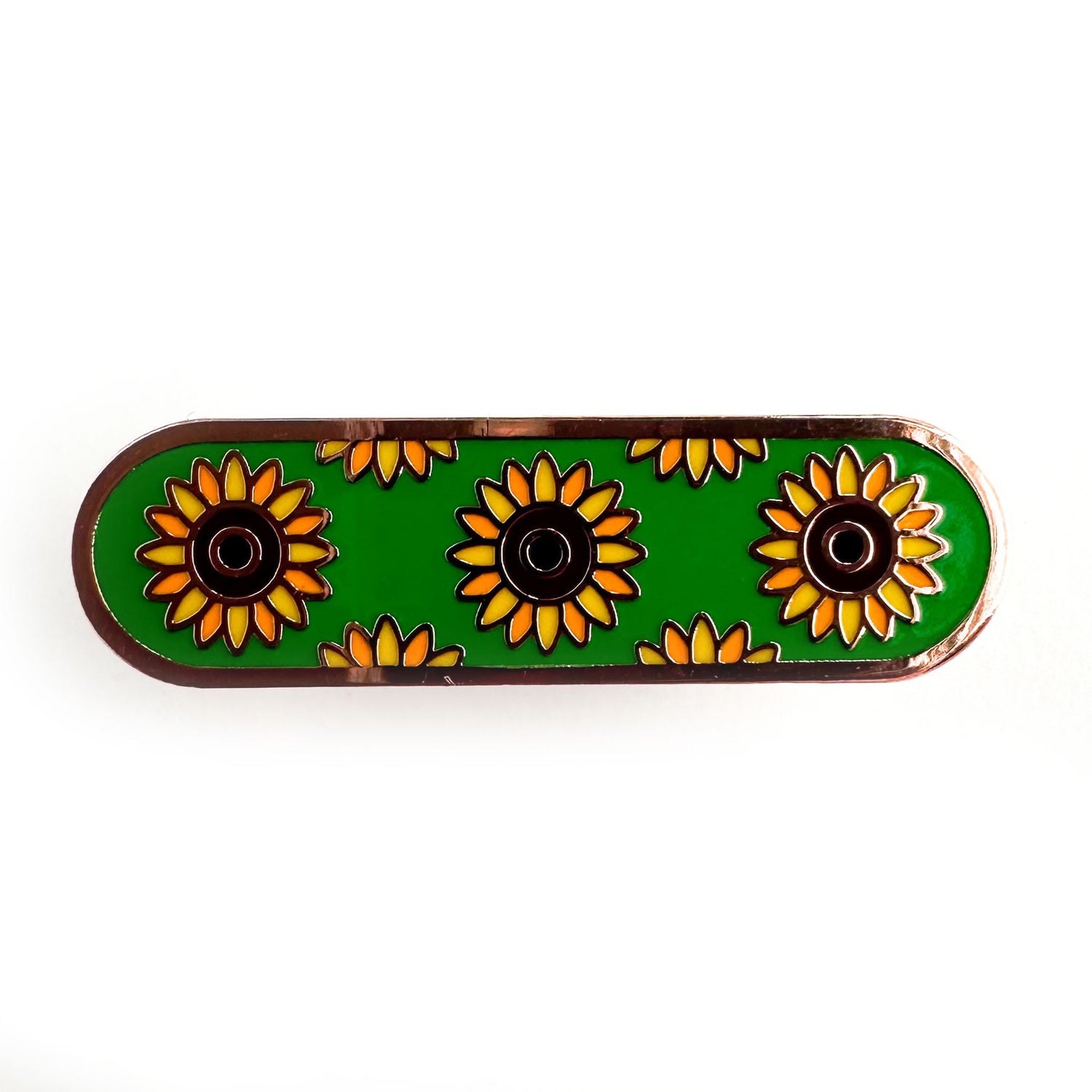 A capsule shaped pin with illustrations of sunflowers on a green background representing invisible disabilities. 