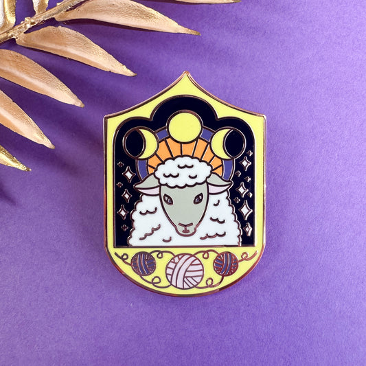 The same sheep in from the previous photo on a purple background with gold leaves in the top left corner
