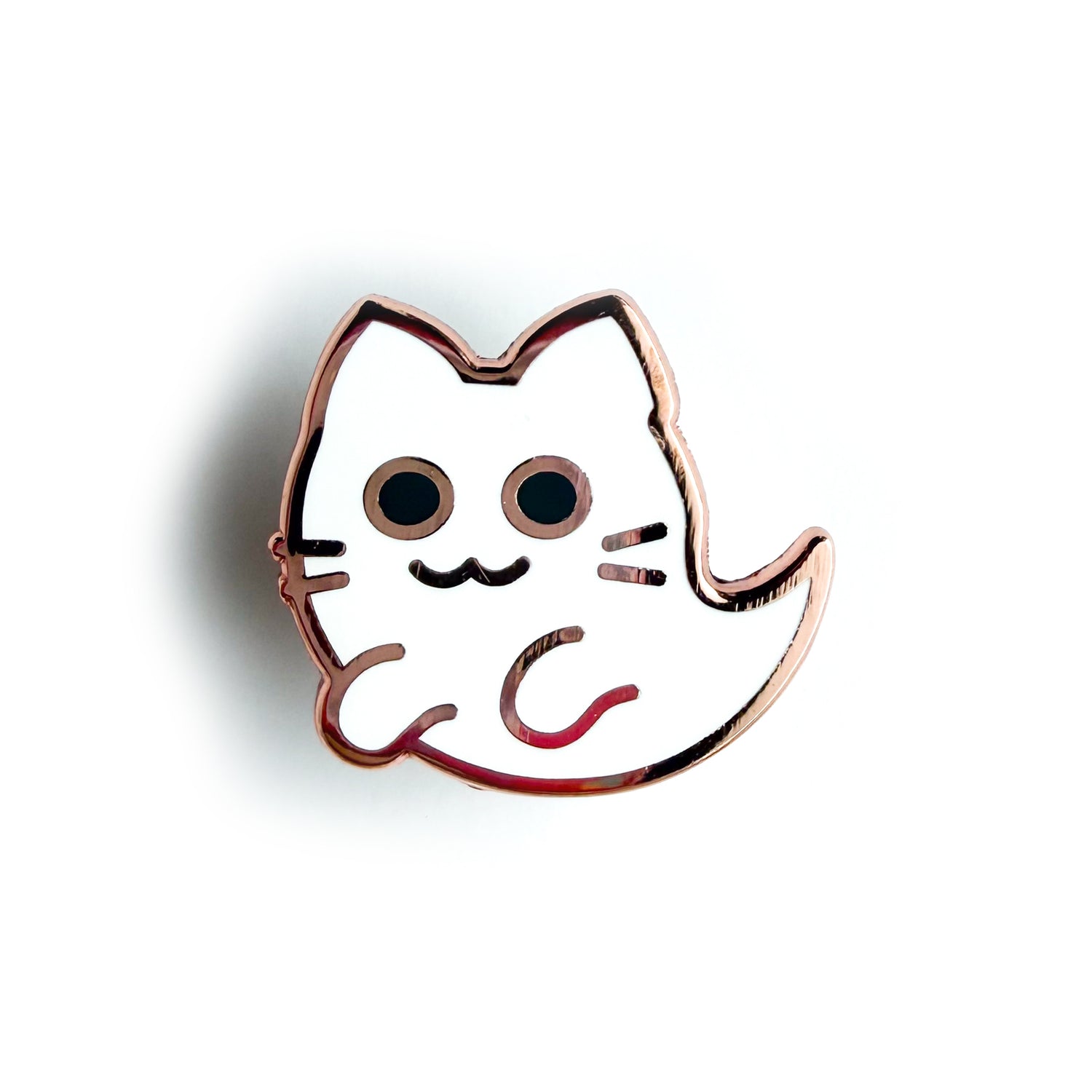 An enamel pin in the shape of a cute kitty ghost.